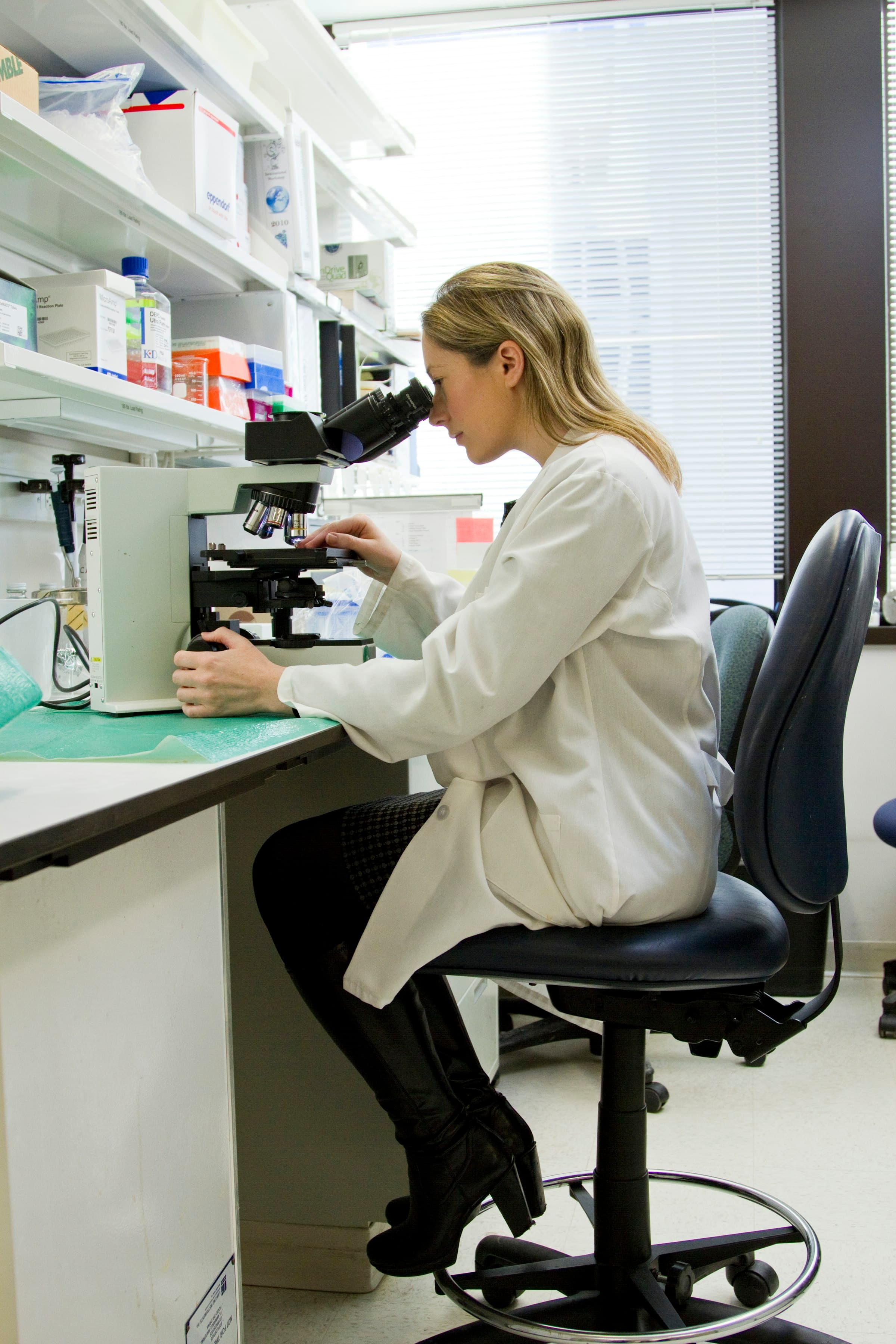 Scientist at a microscope in the BioRacc research laboratory